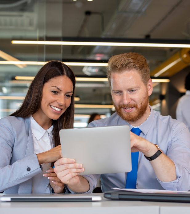 Two People Looking at Tablet — Schedule a Demo